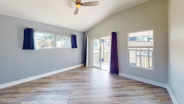 spare room with ceiling fan, vaulted ceiling, and light wood-type flooring