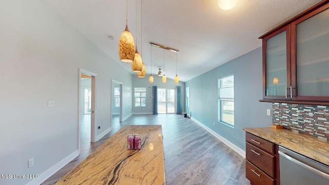 dining room featuring vaulted ceiling and hardwood / wood-style floors