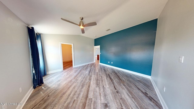 unfurnished bedroom featuring ceiling fan, lofted ceiling, and light hardwood / wood-style floors