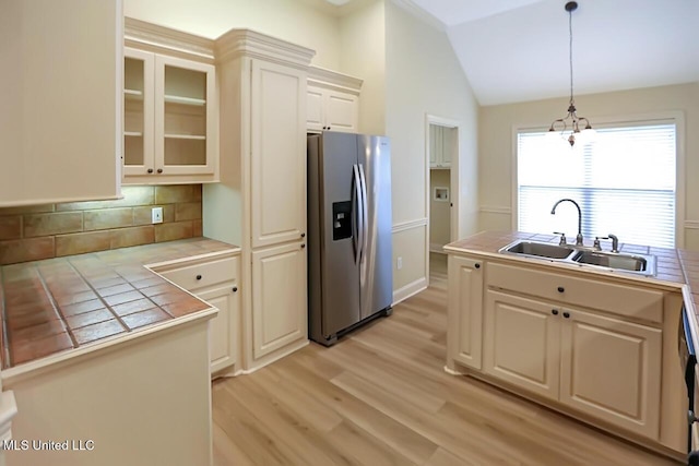 503 W Abbey Pl, Brandon, MS 39047 - kitchen with stainless steel refrigerator with ice dispenser, tile counters, hanging light fixtures, decorative backsplash, and lofted ceiling