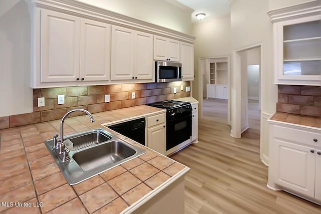 503 W Abbey Pl, Brandon, MS 39047 - kitchen featuring black range oven, stainless steel microwave, dishwashing machine, backsplash, and light countertops