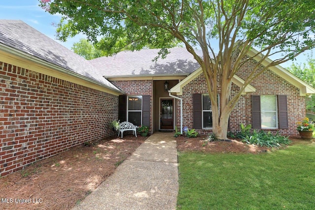 503 W Abbey Pl, Brandon, MS 39047 - view of front of home featuring brick siding, a front lawn, and a shingled roof