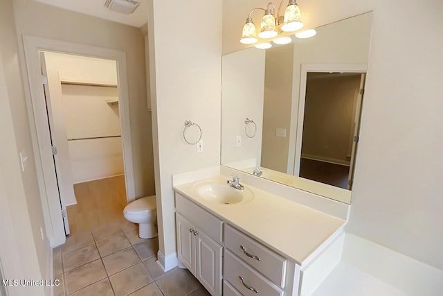 503 W Abbey Pl, Brandon, MS 39047 - bathroom featuring vanity, a chandelier, tile patterned flooring, and a walk in closet