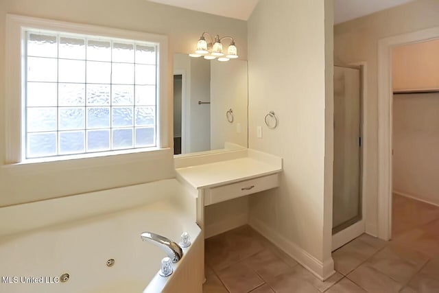 503 W Abbey Pl, Brandon, MS 39047 - bathroom featuring tile patterned floors, plenty of natural light, and a jetted tub