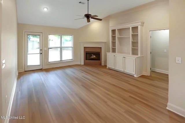 503 W Abbey Pl, Brandon, MS 39047 - unfurnished living room with light wood finished floors, a ceiling fan, and a fireplace
