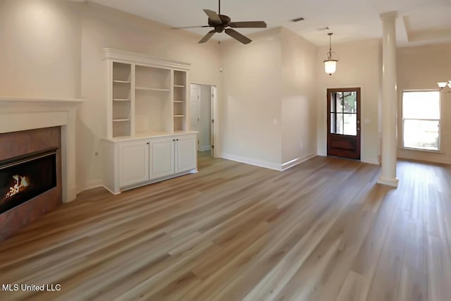 503 W Abbey Pl, Brandon, MS 39047 - unfurnished living room featuring a ceiling fan, light wood-style flooring, and a fireplace