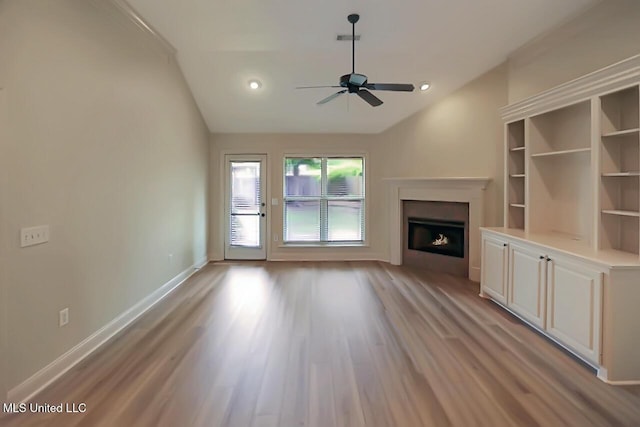 503 W Abbey Pl, Brandon, MS 39047 - unfurnished living room with a warm lit fireplace, ceiling fan, light wood-type flooring, lofted ceiling, and recessed lighting