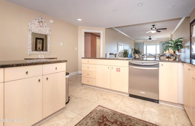 kitchen with dark stone countertops, ceiling fan, kitchen peninsula, and stainless steel dishwasher