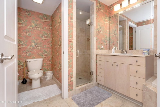 bathroom featuring tile patterned floors, toilet, vanity, and walk in shower