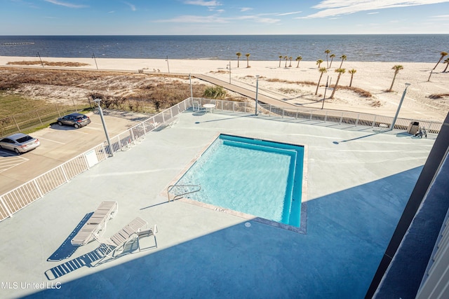 view of pool with a water view