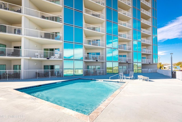 view of swimming pool featuring a patio area