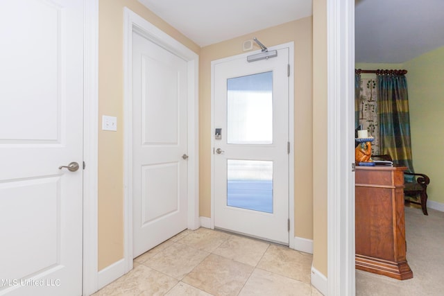 doorway to outside with light tile patterned flooring