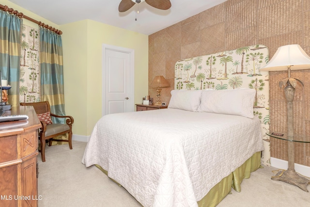 bedroom with ceiling fan and light carpet