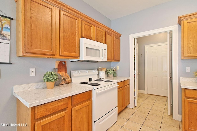 kitchen with white appliances, brown cabinetry, light countertops, light tile patterned floors, and baseboards