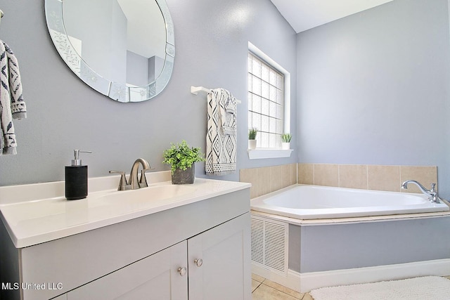 bathroom featuring vanity, a garden tub, and tile patterned flooring