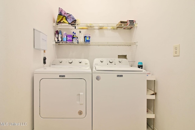 washroom with independent washer and dryer and laundry area