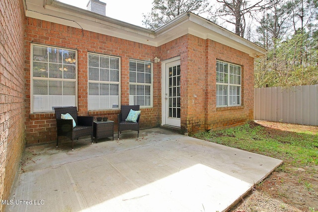 view of patio featuring an outdoor living space and fence