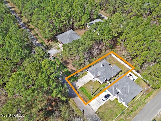 birds eye view of property featuring a wooded view