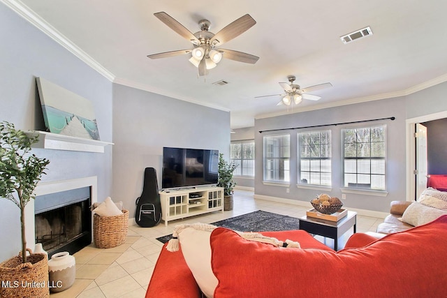 living room with tile patterned floors, visible vents, a fireplace, and crown molding