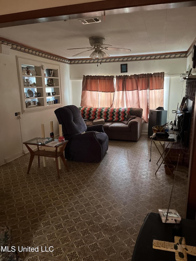 living room featuring built in shelves and ceiling fan