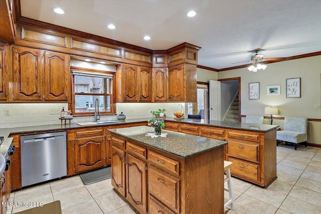 kitchen featuring dishwasher, a center island, sink, backsplash, and ornamental molding