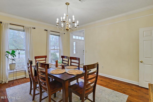 dining room with plenty of natural light, a chandelier, and dark hardwood / wood-style floors