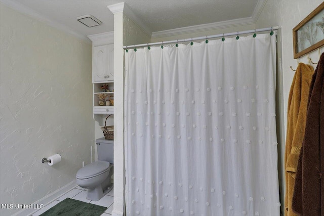 bathroom with toilet, a textured ceiling, tile patterned floors, and ornamental molding