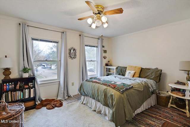 carpeted bedroom featuring a textured ceiling, ceiling fan, and crown molding