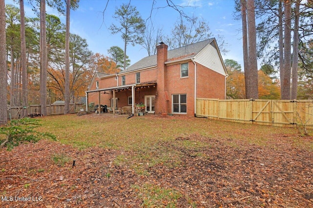 back of property featuring a lawn