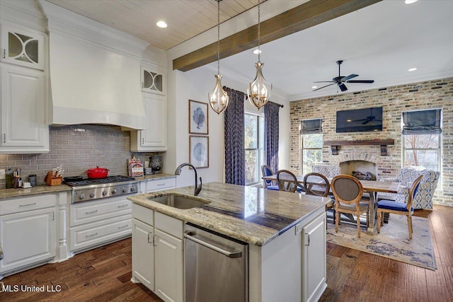 kitchen featuring white cabinetry, sink, and light stone counters