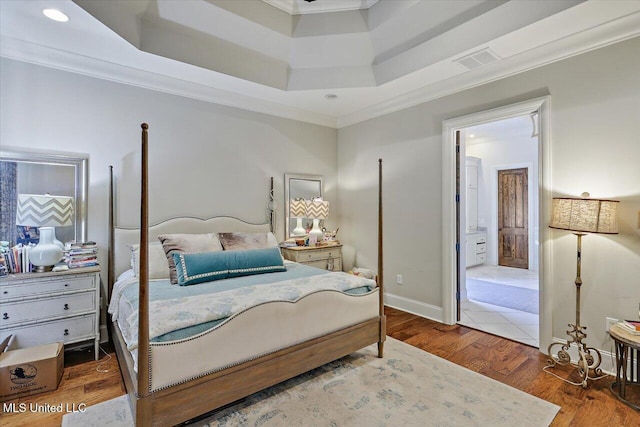 bedroom featuring wood-type flooring and ornamental molding