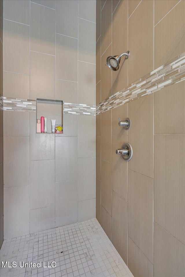 bathroom with tiled shower