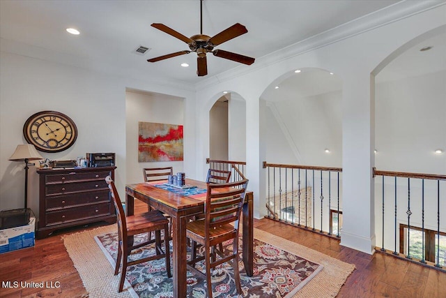 dining space featuring crown molding, ceiling fan, and dark hardwood / wood-style flooring