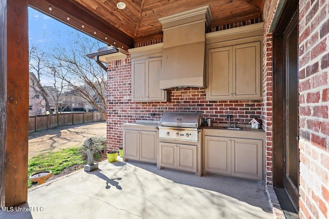 view of patio / terrace with exterior kitchen, a grill, and sink