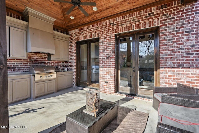 view of patio / terrace with a grill, french doors, ceiling fan, and exterior kitchen