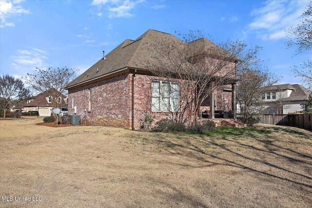 exterior space featuring a lawn and central air condition unit