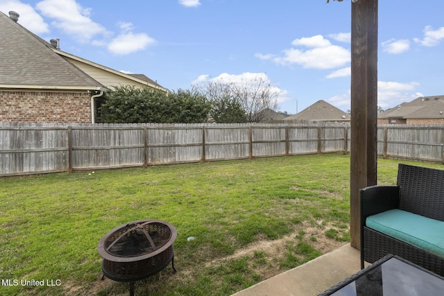 view of yard with a fire pit and a fenced backyard