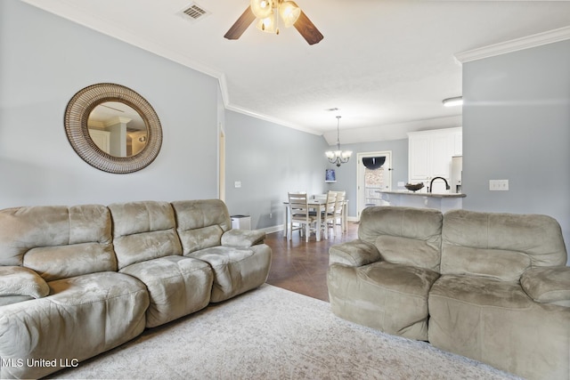 living area with visible vents, ornamental molding, ceiling fan with notable chandelier, wood finished floors, and baseboards