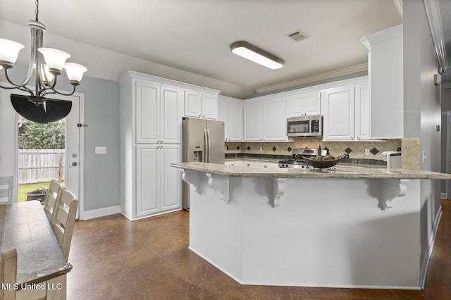 kitchen featuring light stone countertops, visible vents, stainless steel appliances, decorative backsplash, and white cabinetry