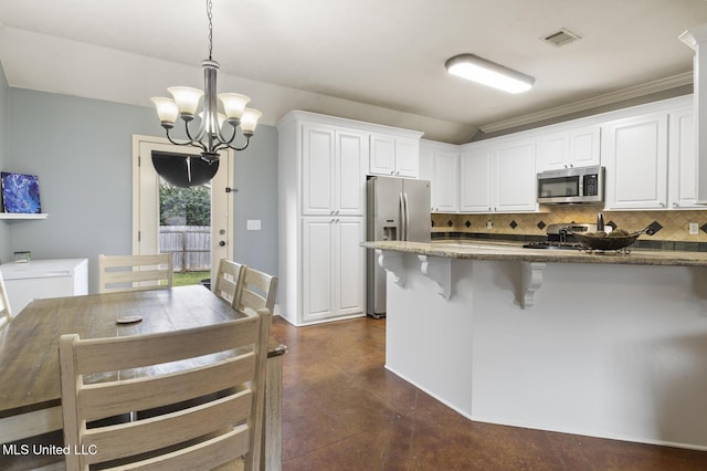 kitchen featuring backsplash, finished concrete flooring, a chandelier, dark stone counters, and stainless steel appliances