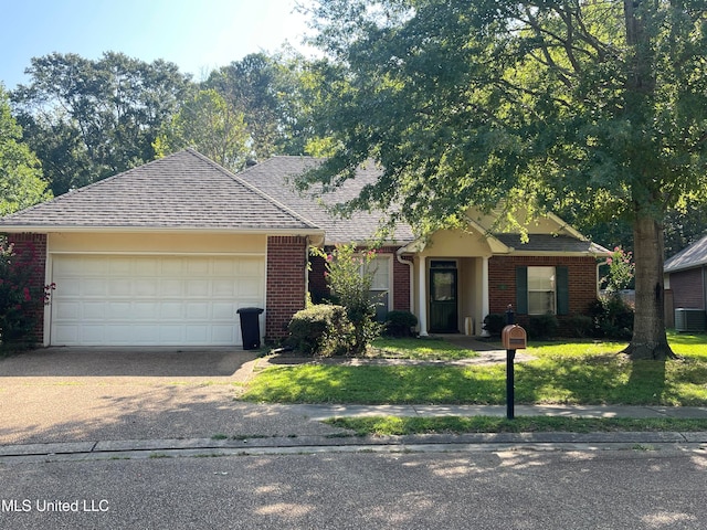 ranch-style home with central air condition unit, a front lawn, and a garage