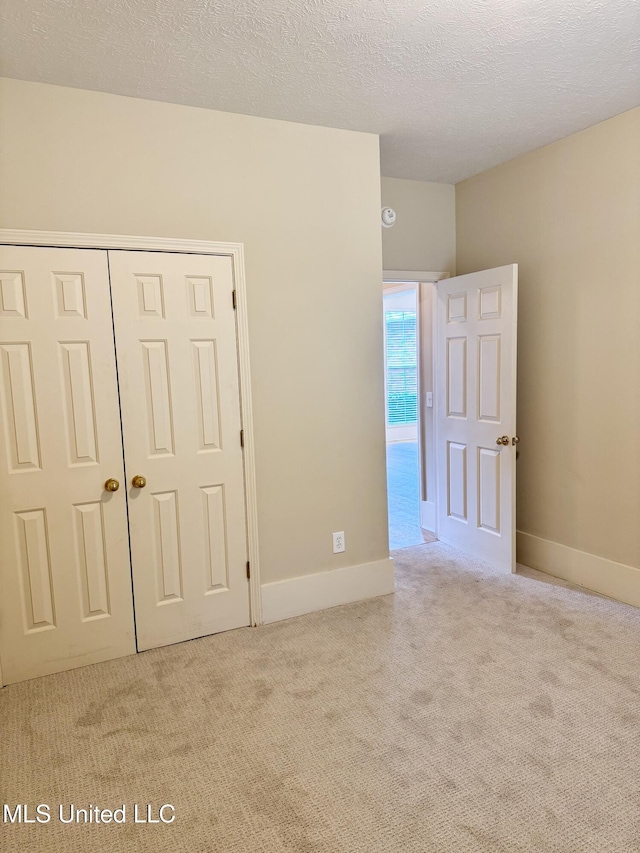 110 Cowles Creek Rd, Clinton, MS 39056 - unfurnished bedroom with carpet flooring, a closet, a textured ceiling, and baseboards