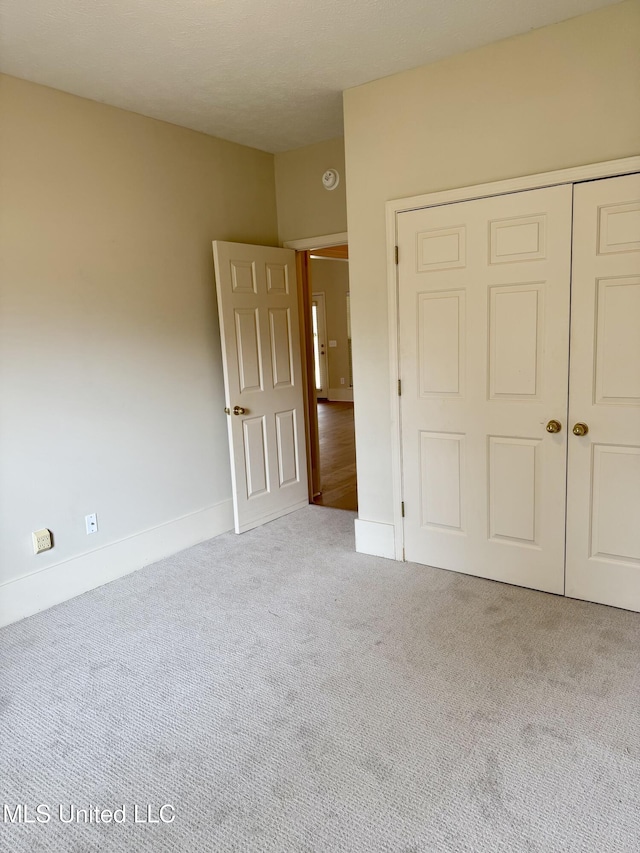 110 Cowles Creek Rd, Clinton, MS 39056 - unfurnished bedroom featuring carpet flooring, a closet, and baseboards