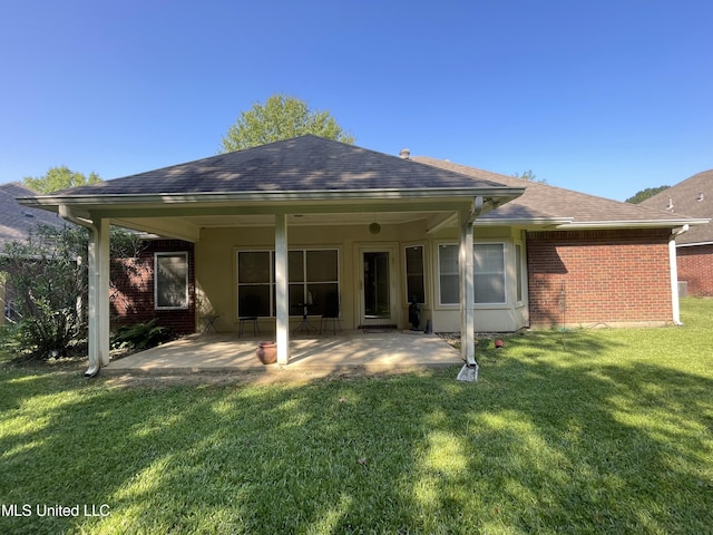 110 Cowles Creek Rd, Clinton, MS 39056 - back of property featuring brick siding, a patio, a shingled roof, and a yard