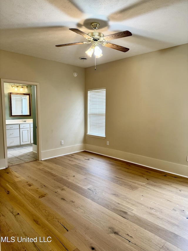 110 Cowles Creek Rd, Clinton, MS 39056 - unfurnished room with a ceiling fan, light wood-style floors, and baseboards