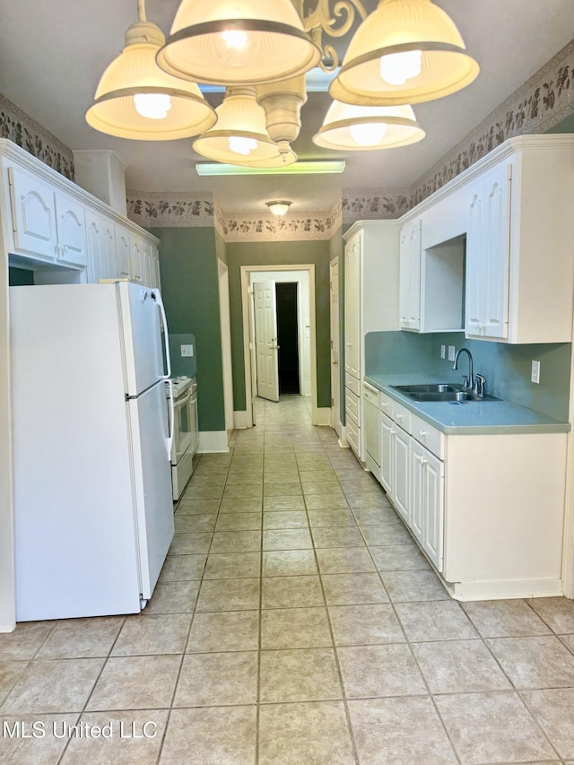 110 Cowles Creek Rd, Clinton, MS 39056 - kitchen with white appliances, a sink, light tile patterned flooring, light countertops, and decorative light fixtures