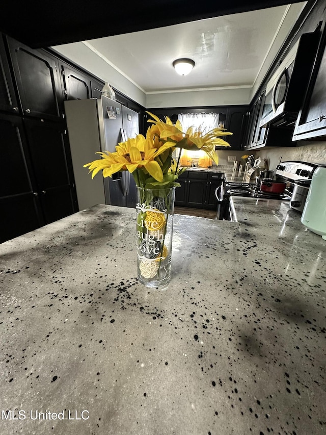 1420 S 9th Ave, Columbus, MS 39701 - kitchen featuring dark cabinets and appliances with stainless steel finishes