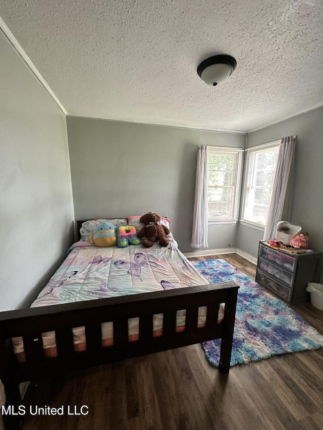 1420 S 9th Ave, Columbus, MS 39701 - bedroom with a textured ceiling and wood finished floors