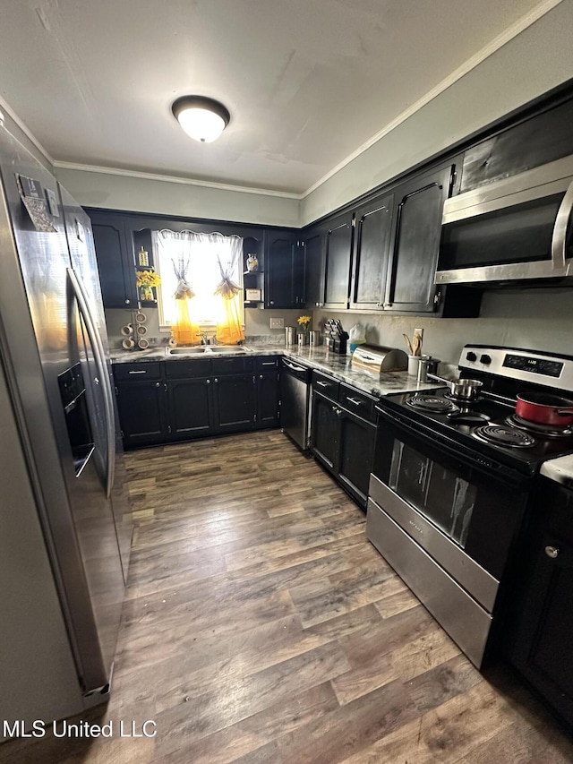 1420 S 9th Ave, Columbus, MS 39701 - kitchen featuring dark wood-style flooring, appliances with stainless steel finishes, a sink, light stone counters, and dark cabinets
