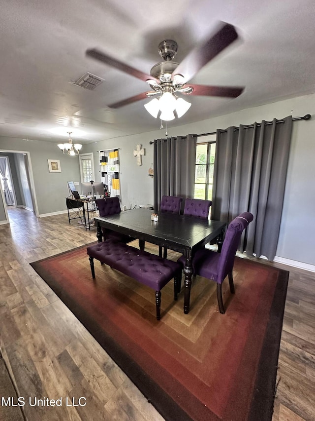 1420 S 9th Ave, Columbus, MS 39701 - dining space with baseboards, ceiling fan with notable chandelier, wood finished floors, and visible vents